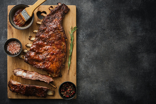 Delicious barbecued ribs seasoned with a spicy basting sauce. Smoked American style pork ribs