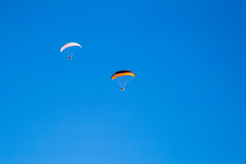 Paragliders in the blue sky