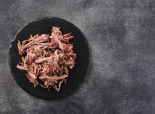 istock Traditional barbecue pulled pork. Slow cooked pulled pork shoulder. Juicy pork meat cooked in a smoker by low and slow 1458271417