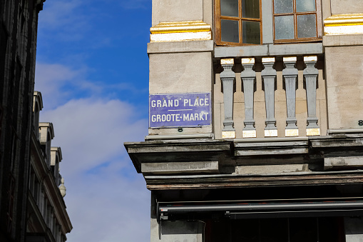 Brussels, Belgium - September 16, 2022: At the corner of the building there is a blue plaque with the name of the square where this building is located. The name is Grand' Place , Groote-Markt