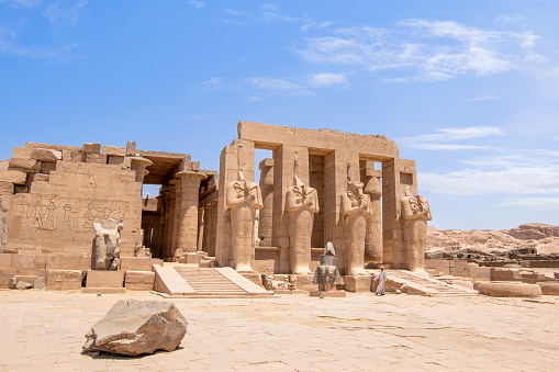 Ramesseum, Theban Necropolis, Luxor, Egypt - July 27, 2022:  The Ramesseum is the memorial temple (or mortuary temple) of Pharaoh Ramesses II. It is located in the Theban Necropolis in Upper Egypt, on the west of the River Nile, across from the modern city of Luxor. The name – or at least its French form Rhamesséion – was coined by Jean-François Champollion, who visited the ruins of the site in 1829 and first identified the hieroglyphs making up Ramesses's names and titles on the walls.