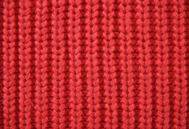 柔らかいセーターの背景に赤いニットテクスチャー。クリスマスの背景。