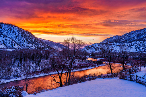 Colorful Dramatic Sunset in Winter River Landscape - Eagle River, Colorado USA.