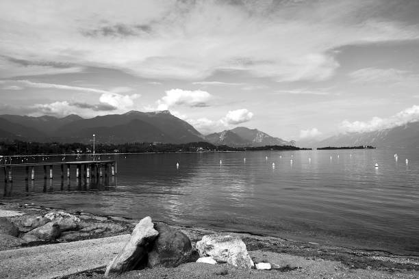 istock Boulders on a pebble beach and mountains on Lake Garda 1458284560