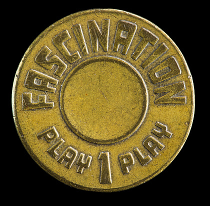 Close up of a token from the 1950s amusement park or boardwalk game, Fascination.
