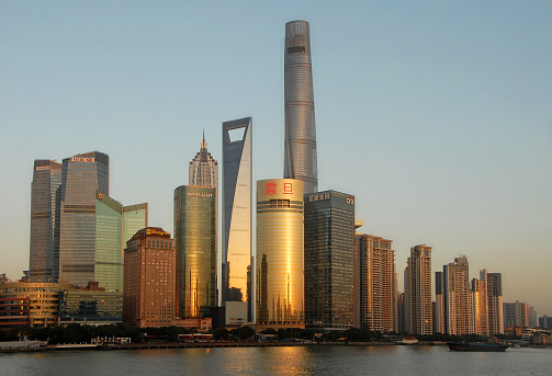 Shanghai skyline, China: The tall modern buildings in the business district of Lujiazui in Pudong, Shanghai with the Huangpu River in the foreground.