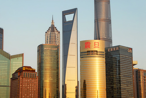 The tall modern buildings in the business district of Lujiazui in Pudong, Shanghai, China. View of the Shanghai Tower and World Financial Center.
