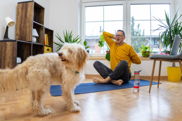 istock Man feels the pain in his back, while practise yoga at home 1458287598