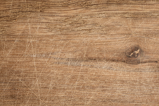 Texture of an old brown wooden board with scratches, oak wood