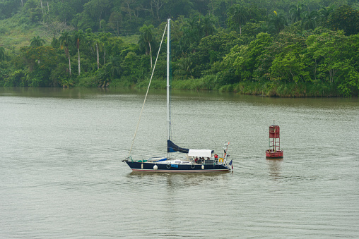 Sailboat transiting the Panama canal at the Miraflores locks