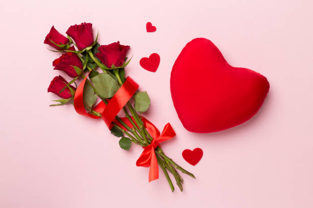 istock Valentines day gift with red roses on color background, top view 1458291165