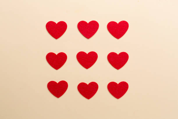 Felt hearts on color background, top view Felt hearts on color background, top view felt heart shape small red stock pictures, royalty-free photos & images