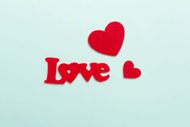 Felt word love with hearts on color background, top view Felt word love with hearts on color background, top view felt heart shape small red stock pictures, royalty-free photos & images