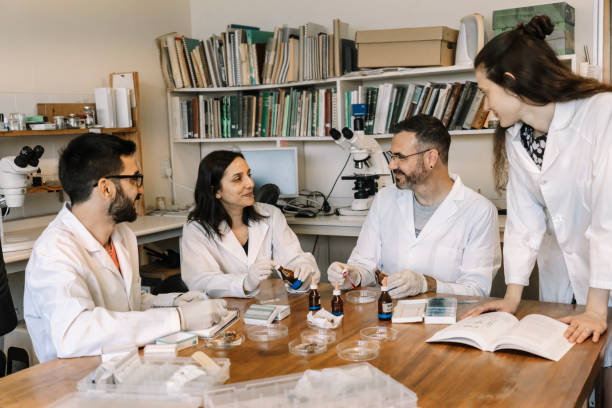 istock Group of scientists studying and researching in chemistry lab . 1458301103
