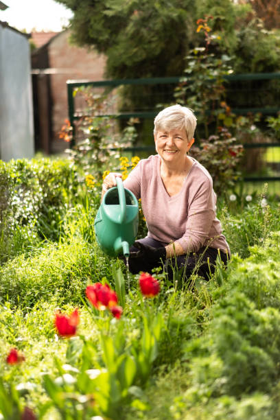 istock grandma is watering the flowers 1458304438