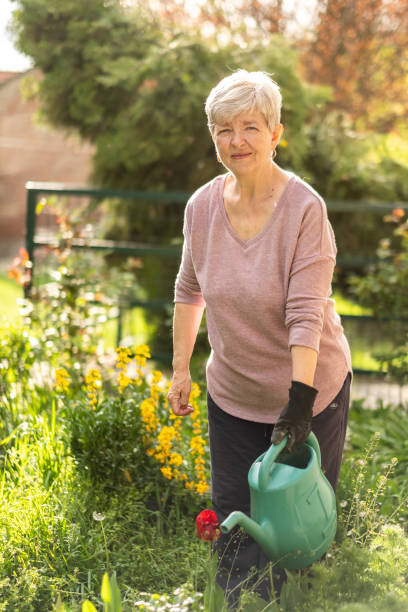 istock grandma is watering the flowers 1458305530