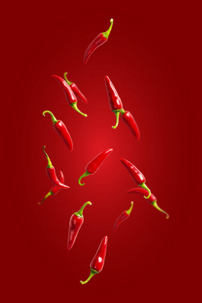 istock Fresh red chilli peppers floating in the air. food levitation. Falling red chilli pappers. 1458305859