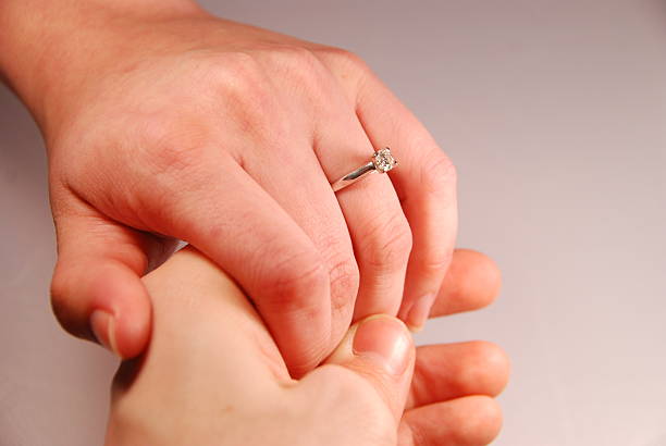 Two hands holding with engagement ring stock photo