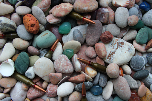 Pebble Gun Bullets Bullets For A Gun Under Smooth Colored Stones And Seashells Texture ...