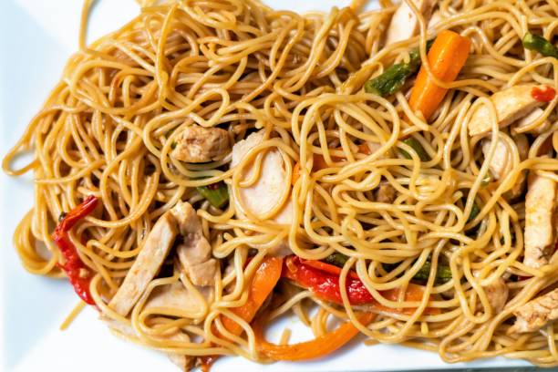 istock Noodles with chicken, red and green pepper, carrots 1458313621