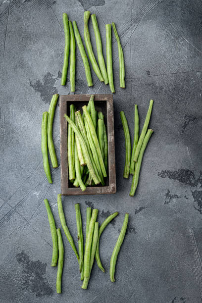 istock Green string bean, in wooden box, on gray stone background, top view flat lay, with copy space for text 1458318268