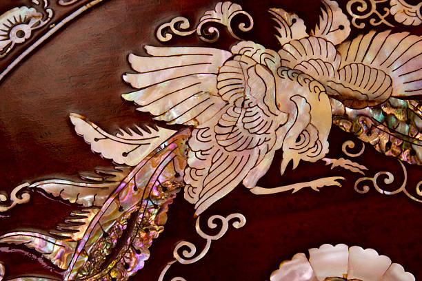 Mother-of-Pearl bird inlay in wood tray.