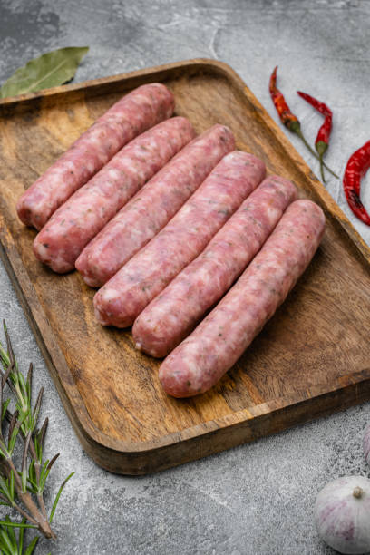 istock A natural raw sausage, on gray stone table background 1458321973