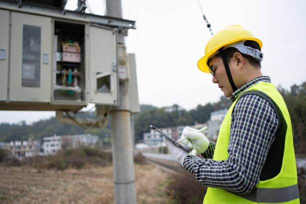 istock Worker inspects substation with iPad 1458327189