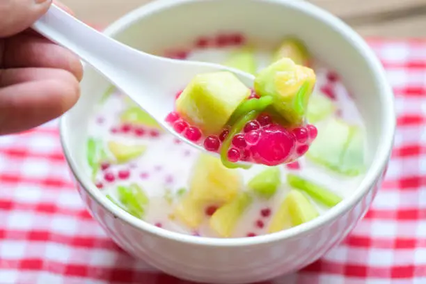 Photo of Thai dessert - Thai rice flour pandan leaf cantaloupe jelly mixed fruit with coconut milk and syrup sweets dessert on bowl, Asian food