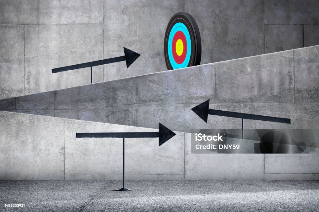 Arrows Point the Way Toward A Target Large arrows on stands point the way up a series of concrete walkways toward a target. Adversity Stock Photo