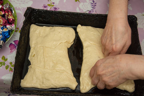 istock preparing the dough for the cheese pie. 2 pies in a black pan 1458338551