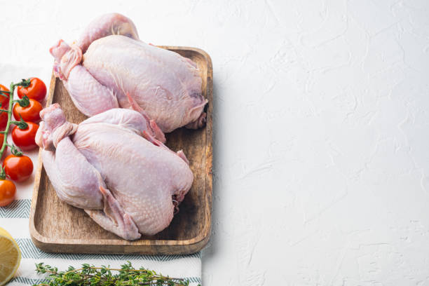 istock Fresh raw chicken with herbs and ingredients, on white background with copy space for text 1458342363