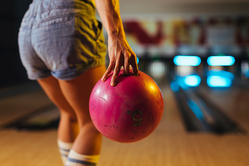 Close-up photo of a woman preparing to throw a bowling ball