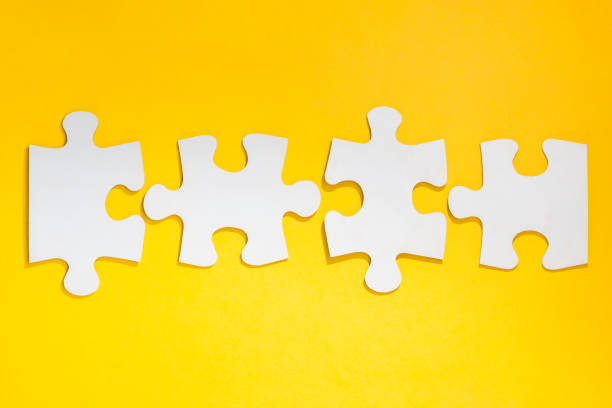istock disconnected jigsaw puzzle in row on yellow background. Blank with four pieces 1458344384