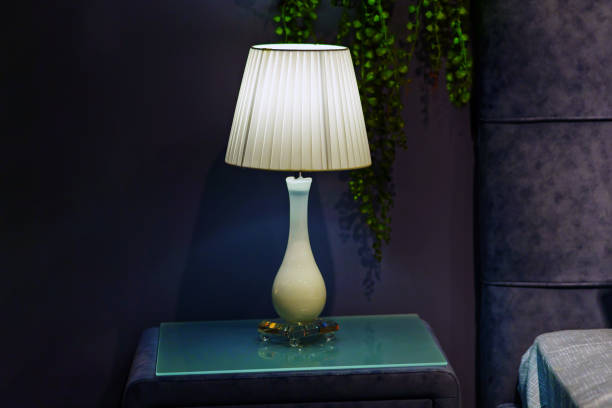 istock An elegant white lamp stands on the bedside table near the bed 1458344764