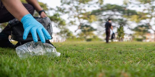 istock Volunteer man collecting trash and reusing plastic cleanup to recycle 1458345009