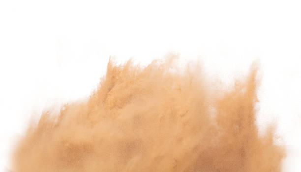 Blur Defocus image of Small Fine Sand flying explosion, Golden grain wave explode blow. Abstract sands cloud. Yellow colored sand splash up in Air. White background Isolated high speed shutter freeze