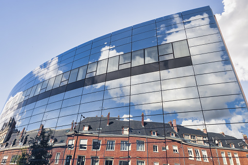 Amiens, France - September 28, 2022: reflecting glass facade of the Maison de la Culture d'Amiens. It is a European center for artistic and cultural creation, production and dissemination in Amiens.