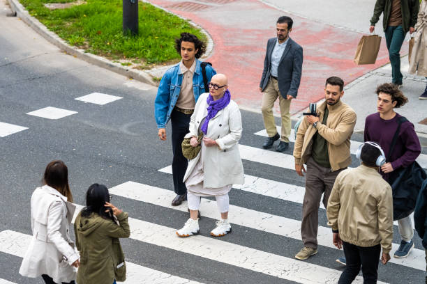 istock Diverse pedestrians walking across zebra top view 1458349555