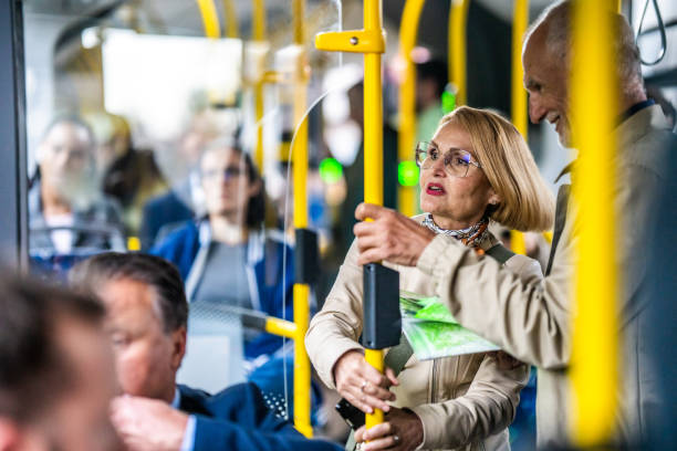 istock Senior couple standing in bus and chatting, medium shot 1458349596