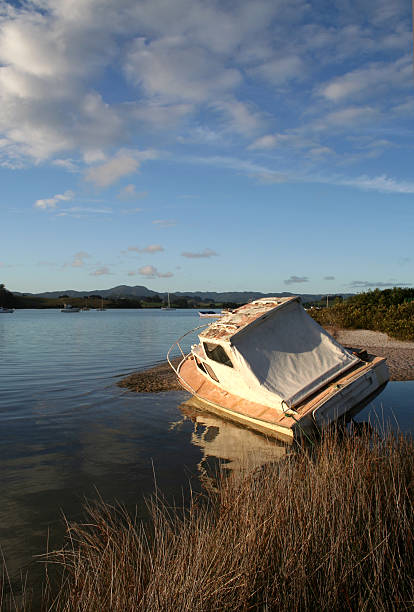 Old boat in the estuary stock photo