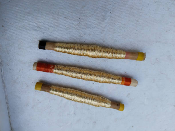 istock Sewing threads golden color closeup, hand loom shuttle spindle, other name zari, jari, taar, golden silk, silver silk, 1458351421