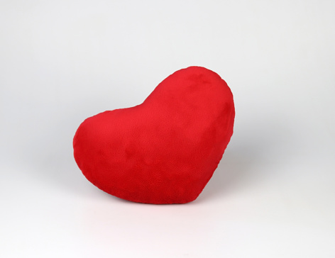 Front view of red heart pillow on white background, isolated. Valentine's day concept.