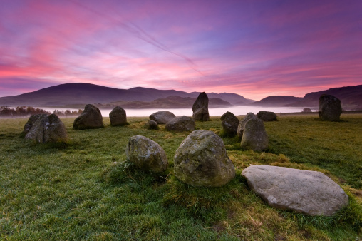 Shot on a very cold, windy morning with a beautiful sunrise amongst the historic stone circle at Castlerigg with some atmospheric mist in the valley