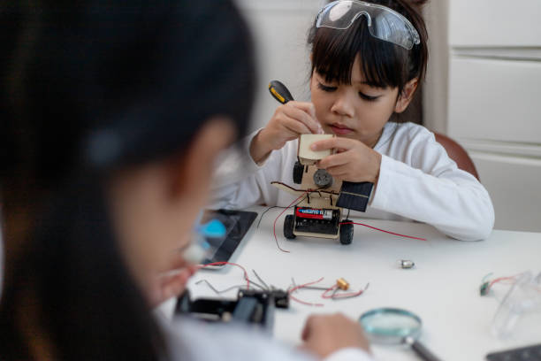 istock Asia students learn at home in coding robot cars and electronic board cables in STEM, STEAM, mathematics engineering science technology computer code in robotics for kids concept. 1458355729