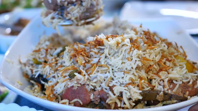mutton biryani meal in a plate on table.