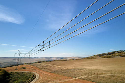 Steel pillar with high voltage electric power lines delivering electrical energy through cable wires on long distance.
