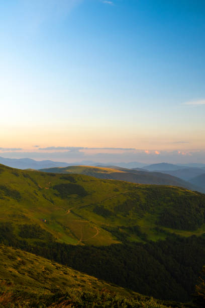 istock Misty evening over high mountain peaks and distant valley at bright sunset. Amazingl scenery of wild hillside at dusk 1458359914