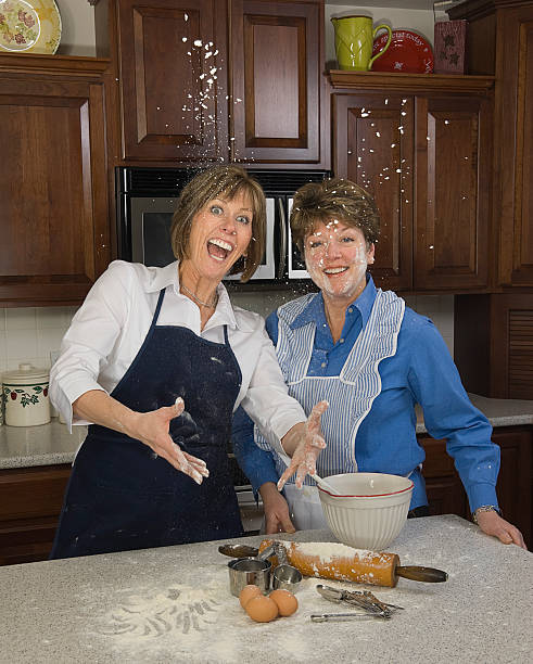 Women Making a Baking Mess in the Kitchen stock photo