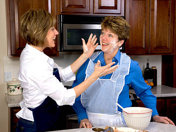Women Playing with Flour in the Kitchen stock photo
